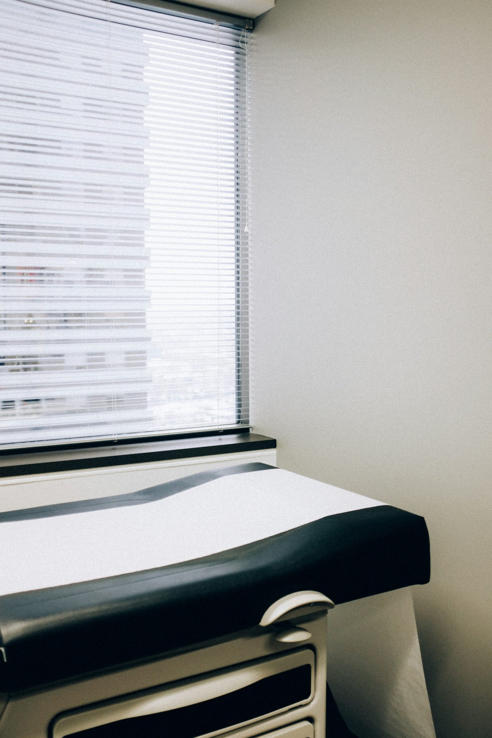 a hospital room with a bed and a window